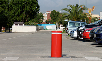 Retractable lacquered iron bollards installed red