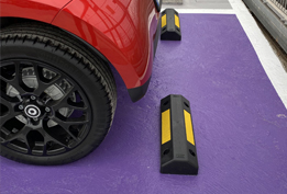 Silver plastic wheel stop for vehicles installed